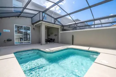 a swimming pool in a house with a glass ceiling at Condominium villas near Disney Orlando Florida in Kissimmee