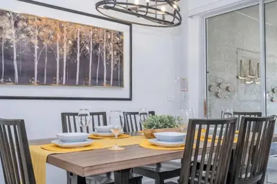 a dining room with a wooden table and chairs at Condominium villas near Disney Orlando Florida in Kissimmee