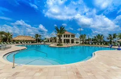 a swimming pool at a resort with palm trees at Themed 5BD Home Movie and Game Room 4726 in Kissimmee