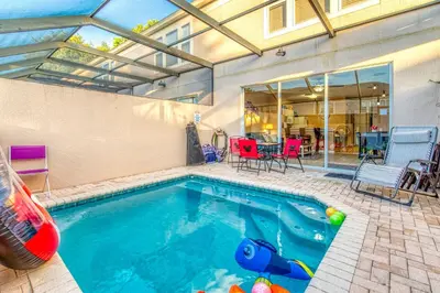 a swimming pool in the backyard of a house at Magical Getaway Close to Disney! Pool, Gym, & WiFi in Kissimmee