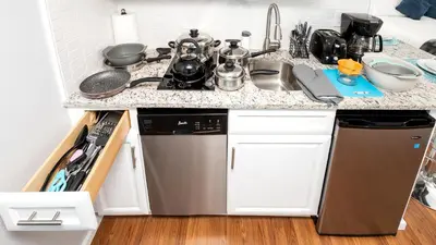 a kitchen counter with a sink and a dishwasher at Gorgeous spot Universal Studios in Orlando