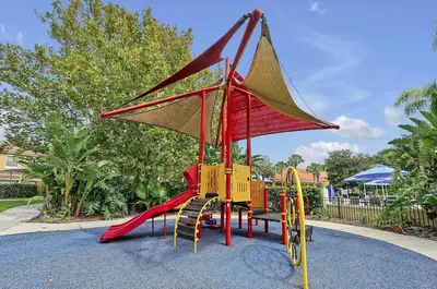 a playground with a slide in a park at Stay Close to Disney in Your 3-Bedroom Haven in Kissimmee