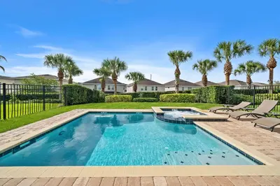 a swimming pool in a yard with palm trees at 7410 Marker Avenue in Orlando