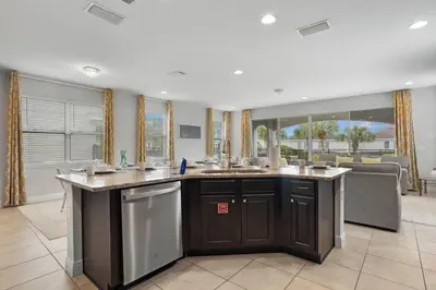 a kitchen with a large island with two sinks at 7410 Marker Avenue in Orlando