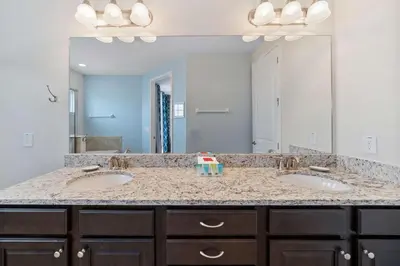 a bathroom with two sinks and a large mirror at 7410 Marker Avenue in Orlando