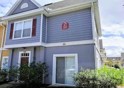 a blue house with a red sign on it at 4 Bedroom 3 Bathroom Villas At Seven Dwarfs 17-107 in Kissimmee