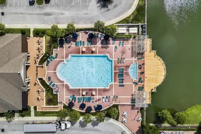 an overhead view of a swimming pool next to the water at 4 Bedroom 3 Bathroom Villas At Seven Dwarfs 17-107 in Kissimmee