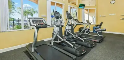 a row of cardio machines in a gym at 161 - 4 bed Gem at Terraverde Resort in Kissimmee