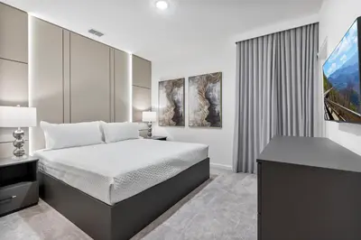 a bedroom with a bed and a desk and a window at Brand NEW 12Bedrooms12Bathroom At Paradiso Grande in Orlando