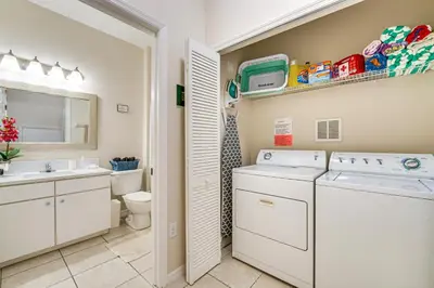 a laundry room with a washer and dryer at 7 Mi to Disney Kissimmee Poolside Paradise! in Kissimmee
