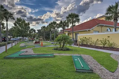 a park with green trampets on the grass at 7 Mi to Disney Kissimmee Poolside Paradise! in Kissimmee