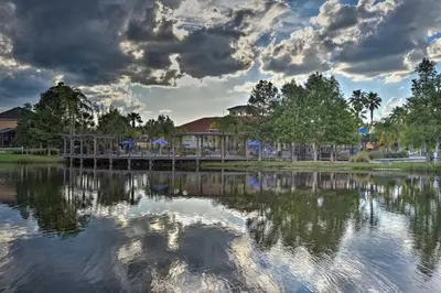 a bridge over a body of water with clouds in the sky at 7 Mi to Disney Kissimmee Poolside Paradise! in Kissimmee