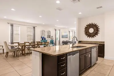 an open kitchen and dining room with a table at Your Dream Vacation Awaits Family 10-Bd Villa in Orlando