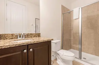 a bathroom with a toilet and a sink and a shower at Your Dream Vacation Awaits Family 10-Bd Villa in Orlando