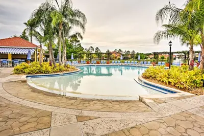 a swimming pool at a resort with palm trees at Private Pool Family-Friendly Kissimmee Townhome! in Kissimmee