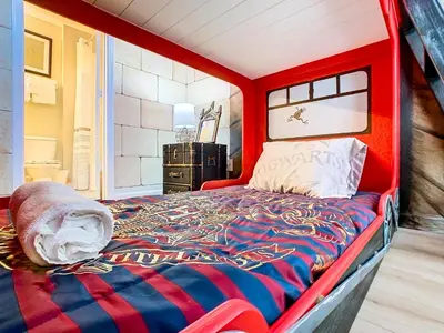 a bed in a room with a red head board at WH7742CS - Newly renovated villa in Windsor Hills in Orlando
