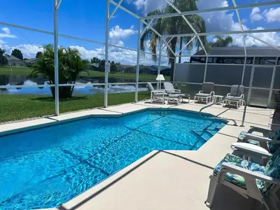 a swimming pool with chaise lounge chairs and a swimming pool at EP1051SEL - Private Vacation Pool Home Near Disney in Kissimmee