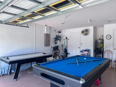 a ping pong table in a room with a pool table at EP1051SEL - Private Vacation Pool Home Near Disney in Kissimmee
