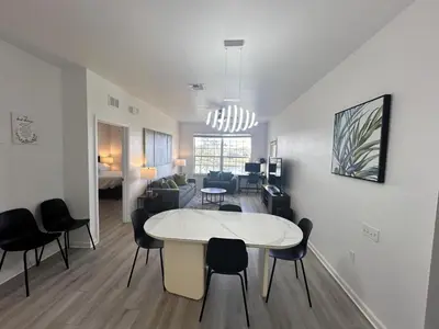 a living room and dining room with a table and chairs at WH7660-205CS - Lakeview on the hills in Orlando