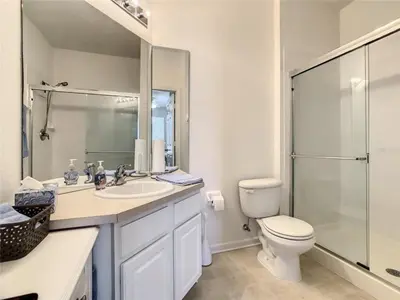 a bathroom with a toilet and a sink and a shower at WH7660-205CS - Lakeview on the hills in Orlando