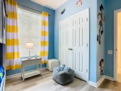 a childs room with blue walls and a white door at WH2778-201AL - Toy Story meets Star Wars in Orlando