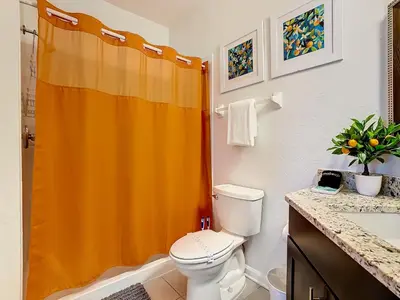 an orange shower curtain in a bathroom with a toilet at WH2778-201AL - Toy Story meets Star Wars in Orlando
