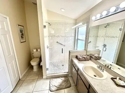 a bathroom with a sink and a shower at EP1015SEL - 4 bedrooms - 8 guests pool home on a lake in Kissimmee