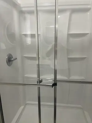 a glass shower stall with a glass door at Mobile Home on huge parking space 10 mins from airport, 20 mins from Disney in Kissimmee