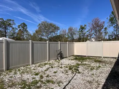 a fence with a bike parked next to it at Mobile Home on huge parking space 10 mins from airport, 20 mins from Disney in Kissimmee