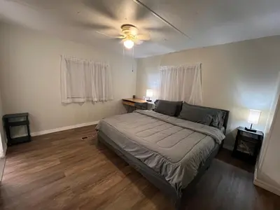 a bedroom with a bed and a ceiling fan at Mobile Home on huge parking space 10 mins from airport, 20 mins from Disney in Kissimmee