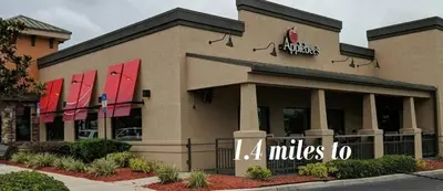 a store front of a mall with red signs on it at 4 Bedroom villa in Lake Berkley, Private Pool Fantastic View, Free WiFi, Theme Parks All Around! in Kissimmee