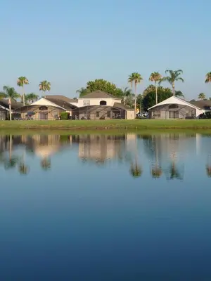 a group of houses sitting next to a large body of water at 637- Huge 5 Bed Villa with Amazing Water Views and Own Private Pool and Spa in Kissimmee