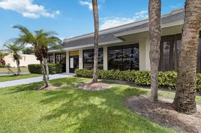 a building with palm trees in front of it at 11 Condo-Hotel With Double Bed And Community Pool Miles From Disney! in Kissimmee