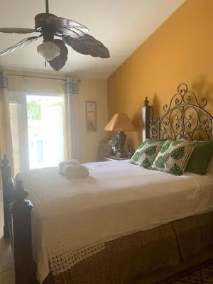 a bedroom with a large bed with a ceiling fan at Spacious Condo Close to Disney Attractions in Kissimmee