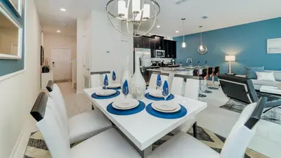 a dining room and kitchen with a white table and chairs at Sea Haven in Orlando