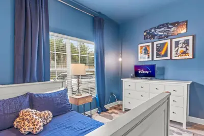 a blue bedroom with a bed and a window at Lake view Pool home near Disney - 5BR 4BA in Kissimmee