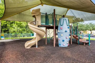 a playground with a slide in a park at Your Home Away from Home! in Kissimmee