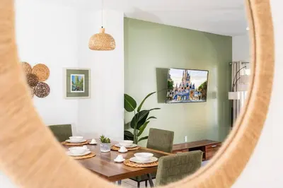 a dining room with a table and chairs and a mirror at Your Home Away from Home! in Kissimmee