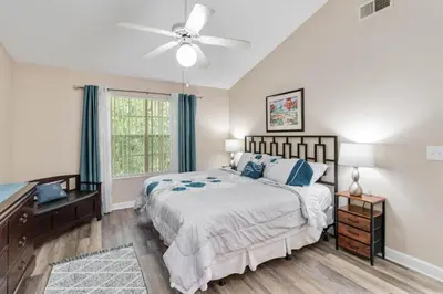 a bedroom with a bed and a ceiling fan at Dream Condo in Kissimmee