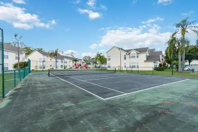 a tennis court in front of some houses at Dream Condo in Kissimmee