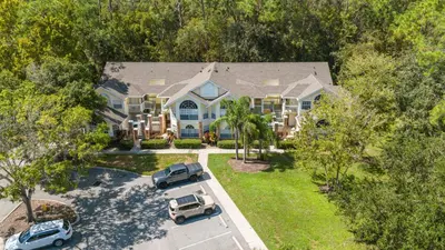 an aerial view of a house with cars parked in a parking lot at Dream Condo in Kissimmee