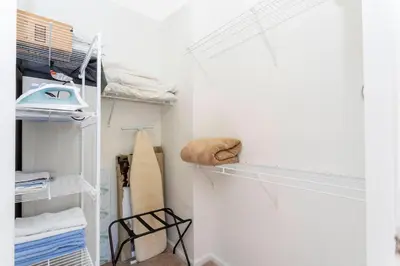a walk in closet with white walls and shelves at Cozy Apartment 3BD2BA at Windsor Hills WH28131 in Orlando