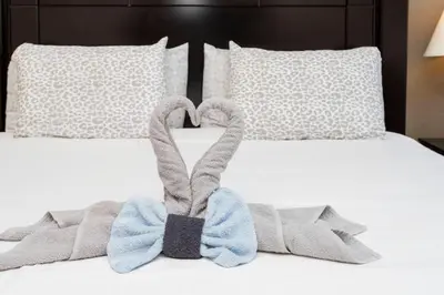 a bed with two towels in the shape of a heart at Cozy Apartment 3BD2BA at Windsor Hills WH28131 in Orlando