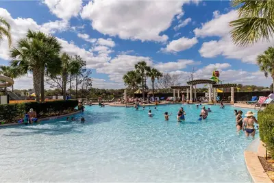a group of people in a swimming pool at a theme park at Cozy 3BR2BA Condo at Windsor Hills Resort WH76604 in Orlando