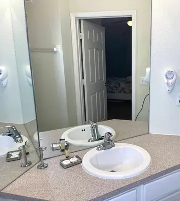 a bathroom with two sinks and a large mirror at Cozy 3BR2BA Condo at Windsor Hills Resort WH76604 in Orlando