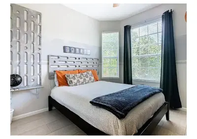 a bedroom with a bed and a large window at Windsor Hills Magic,Resort Waterslides,Pool,Disney in Orlando