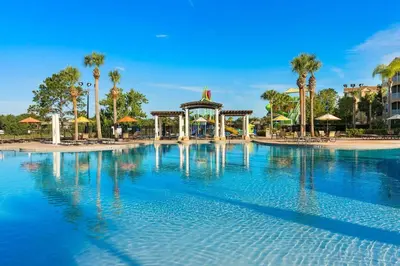 a large swimming pool with a gazebo and palm trees at Windsor Hills Magic,Resort Waterslides,Pool,Disney in Orlando