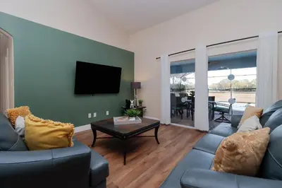 a living room with a couch and a table at Orange Tree Vacation Home with Private Pool and Spa Near Disney in Orlando