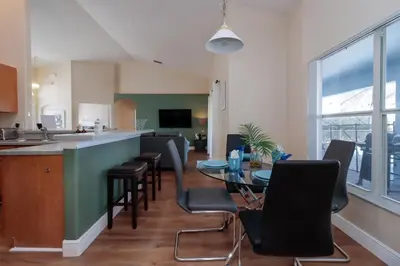 a kitchen and dining room with a table and chairs at Orange Tree Vacation Home with Private Pool and Spa Near Disney in Orlando