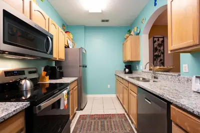 a kitchen with a sink and a stove top oven at Budget Friendly Condo in Windsor Hills Resort w garden view in Orlando